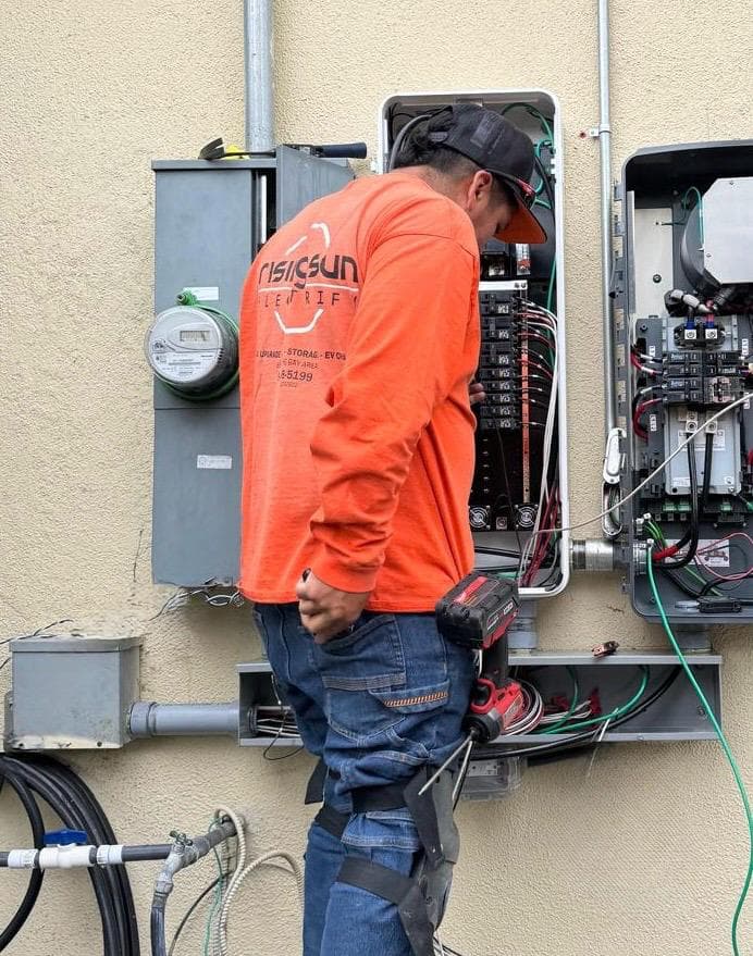 Licensed electrician working on electrical panel